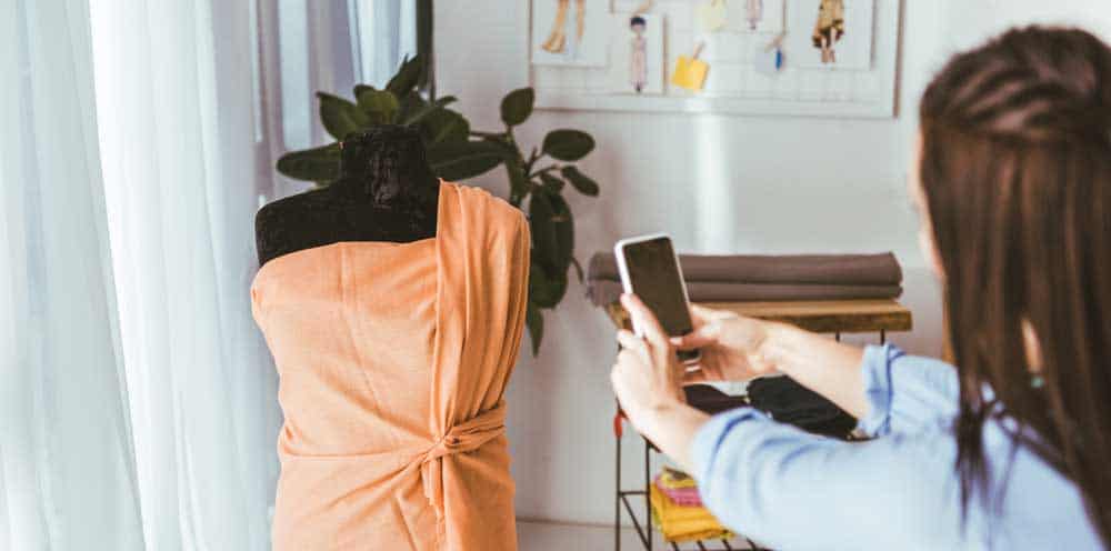 woman taking a photo of a dress or google search