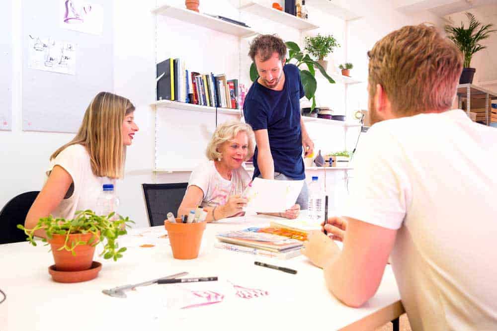 happy old woman looking at paper for approval sent by business owners