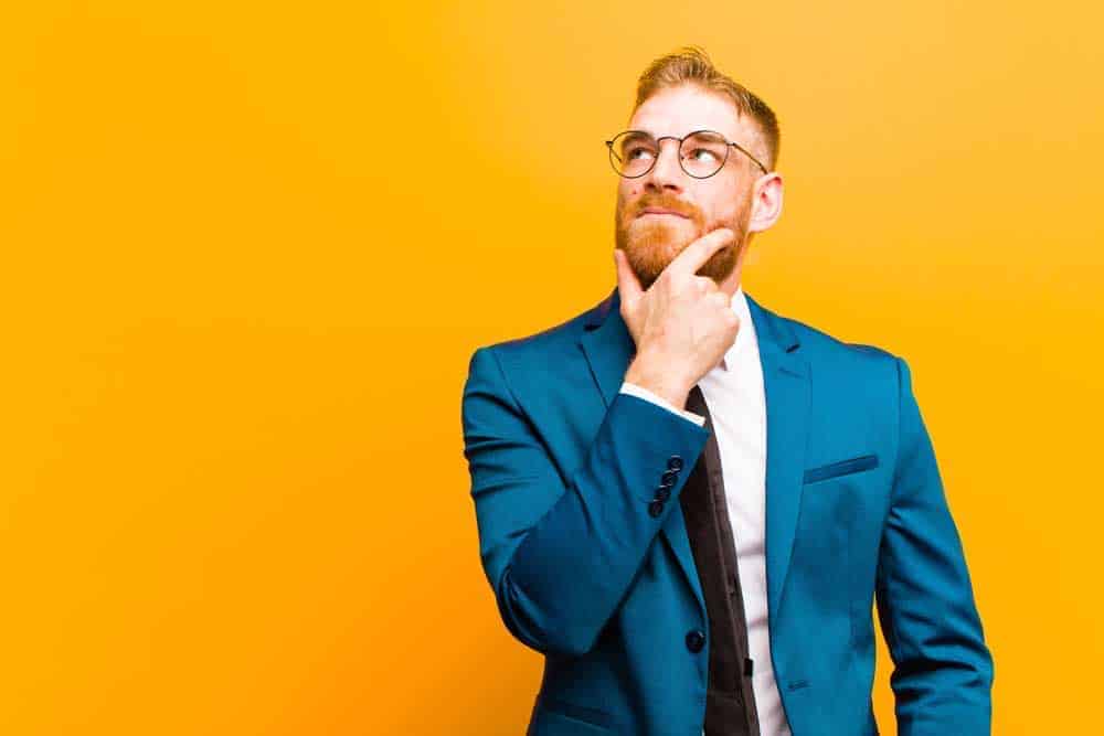 man in yellow background thinking about his USP