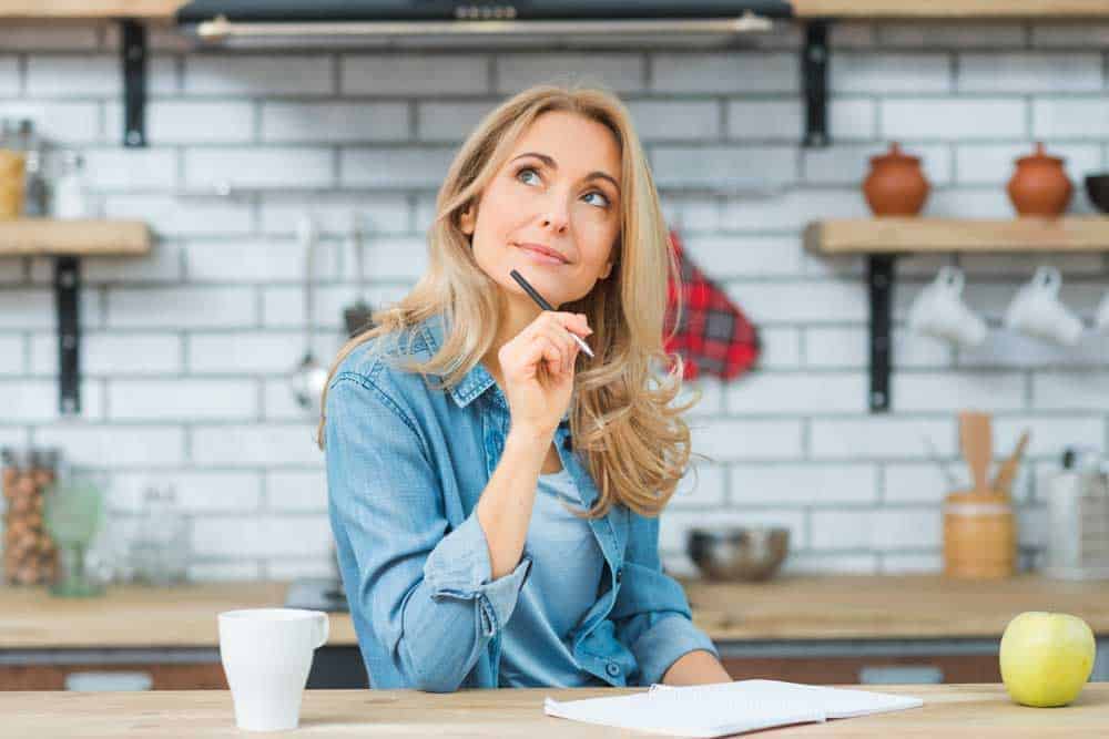woman in kitchen thinking