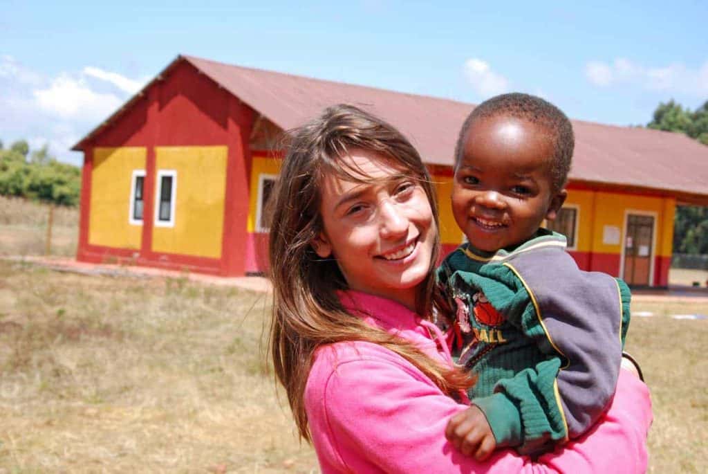 woman for a nonprofit organization holding a child