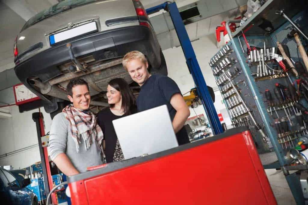 couple checking their car in an auto repair shops